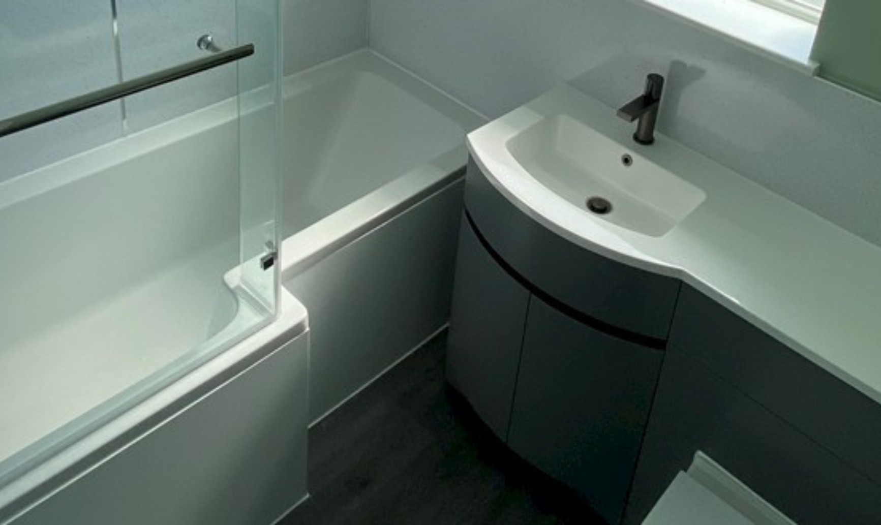 well-designed bathroom with a sink, toilet, and shower, highlighting professional installation and repair services