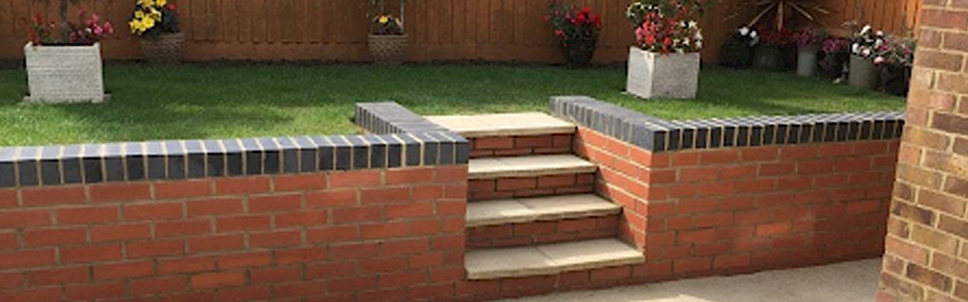 Garden with a raised lawn, surrounded by a brick retaining wall with tiled edges and steps leading to the grass area, ideal for landscaping and outdoor improvements
