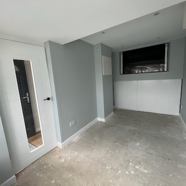 Interior view of a room with a door and window, highlighting general building and construction services