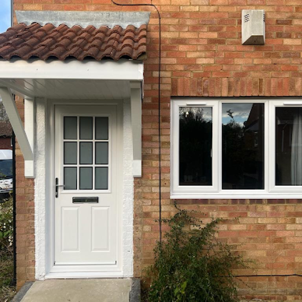 white door and window framed in a brick house, showcasing quality building and construction services