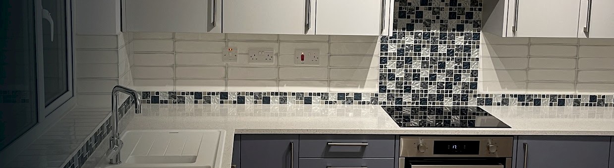 modern kitchen featuring a sink, stove, and oven, showcasing recent installation and repainting work