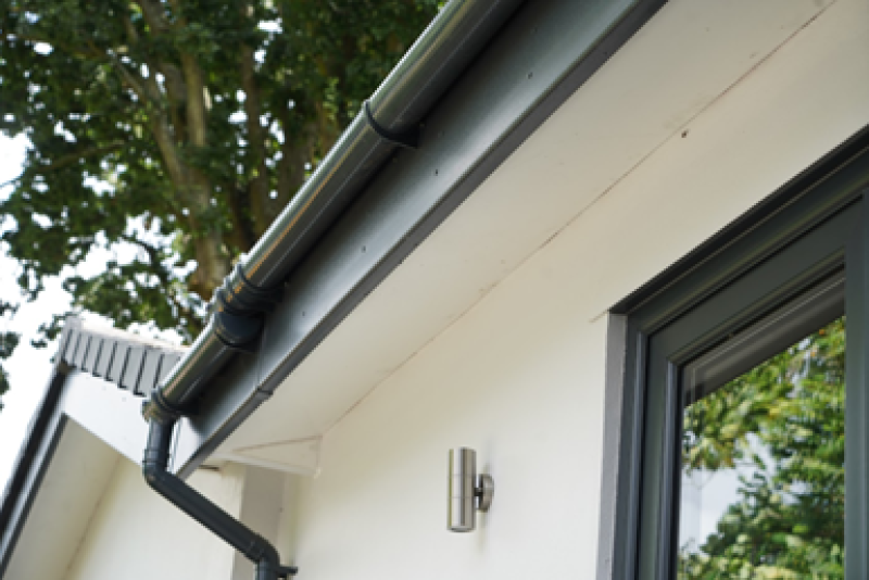 window featuring elegant black and white trim, showcasing quality craftsmanship in roofline facias and guttering services