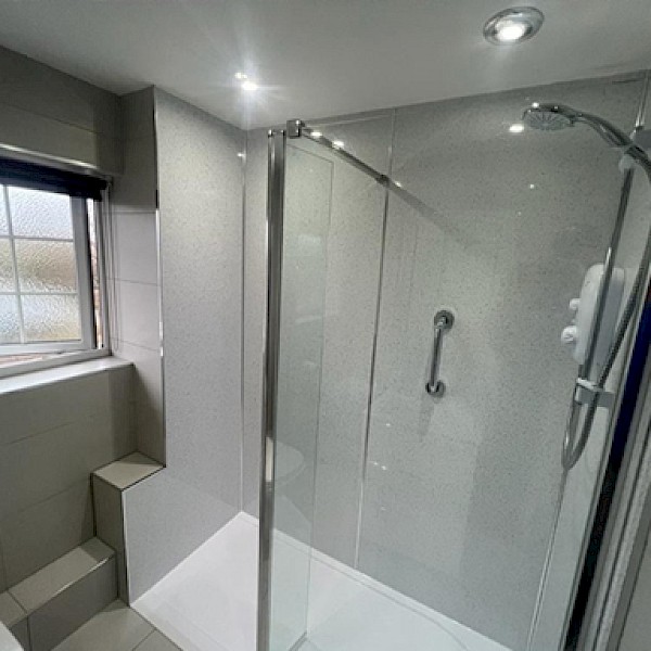 stylish bathroom equipped with a shower, toilet, and sink, emphasizing expert renovation and installation