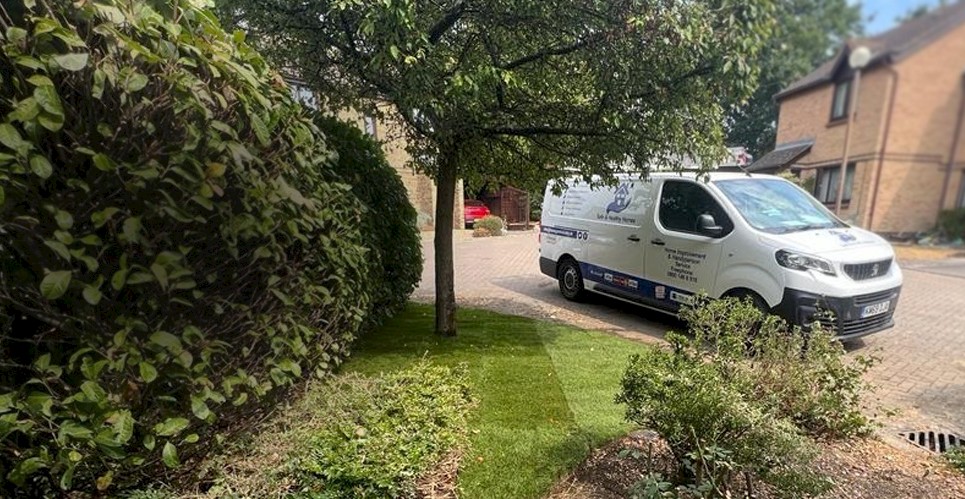 Green garden landscape with handyperson van in the background for Safe and Healthy Homes