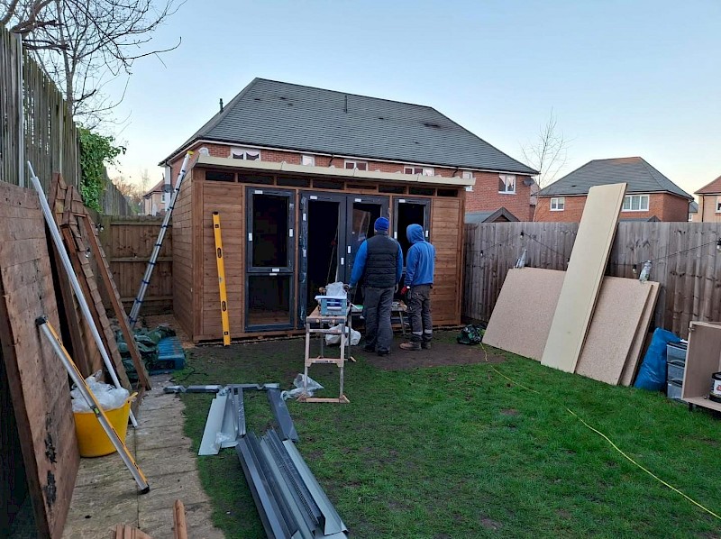 handyman installing a brand new garden room